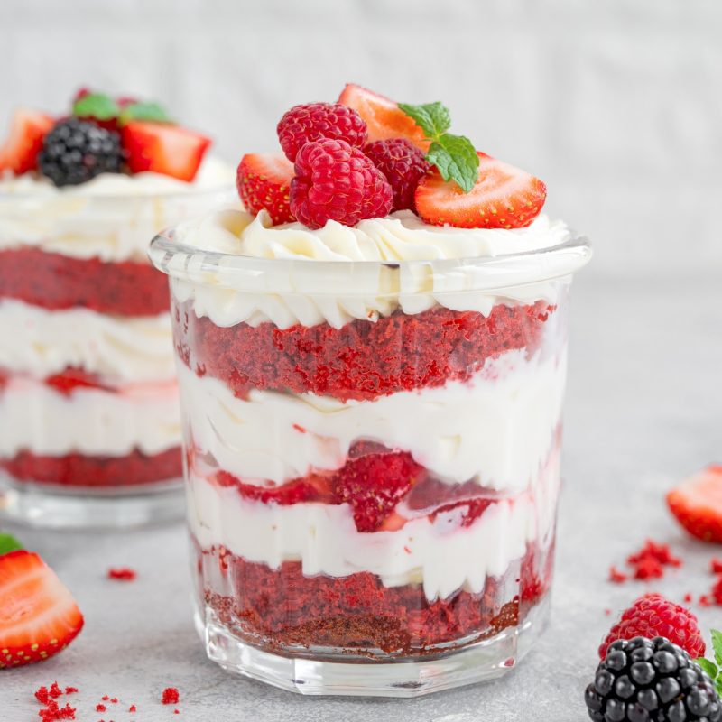 Red Velvet cake trifle with fresh berries in a glass jar. Dessert for Valentine's Day.